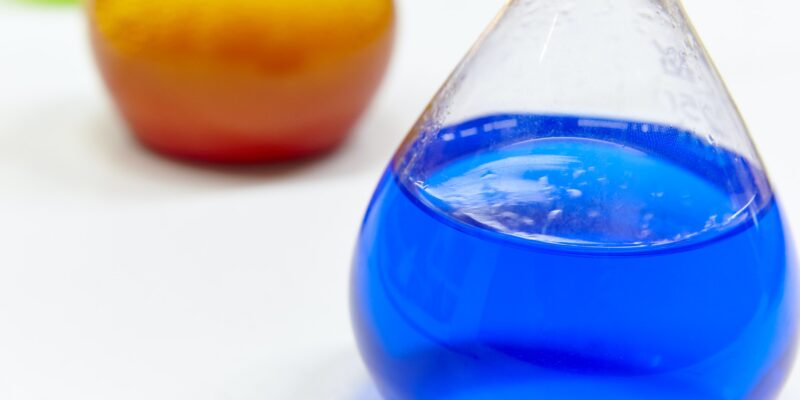 Chemical test flasks with colored lab liquids. Science background. Horizontal