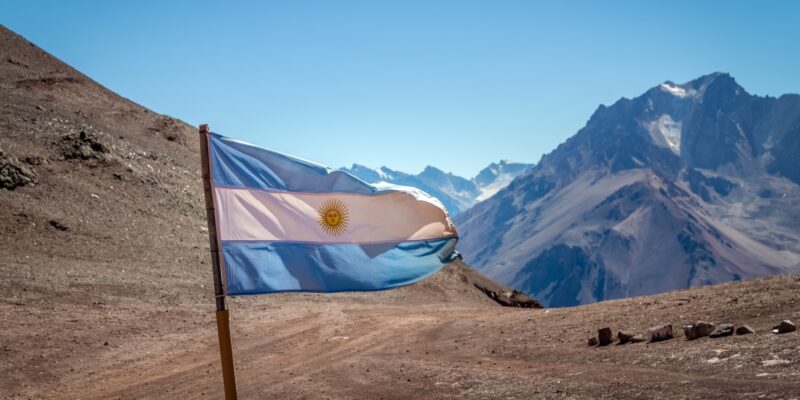 Argentina flag with Cerro Tolosa Mountain in Cordillera de Los Andes - Mendoza Province, Argentina