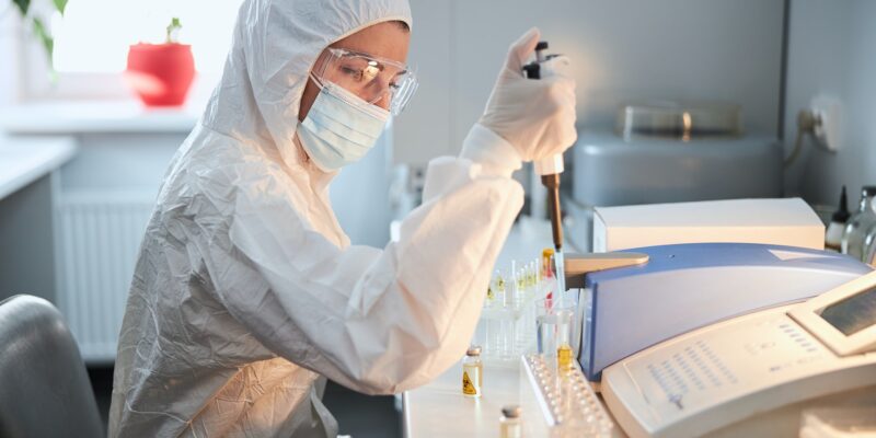 Scientist in a hazmat suit conducting research on a highly pathogenic coronavirus